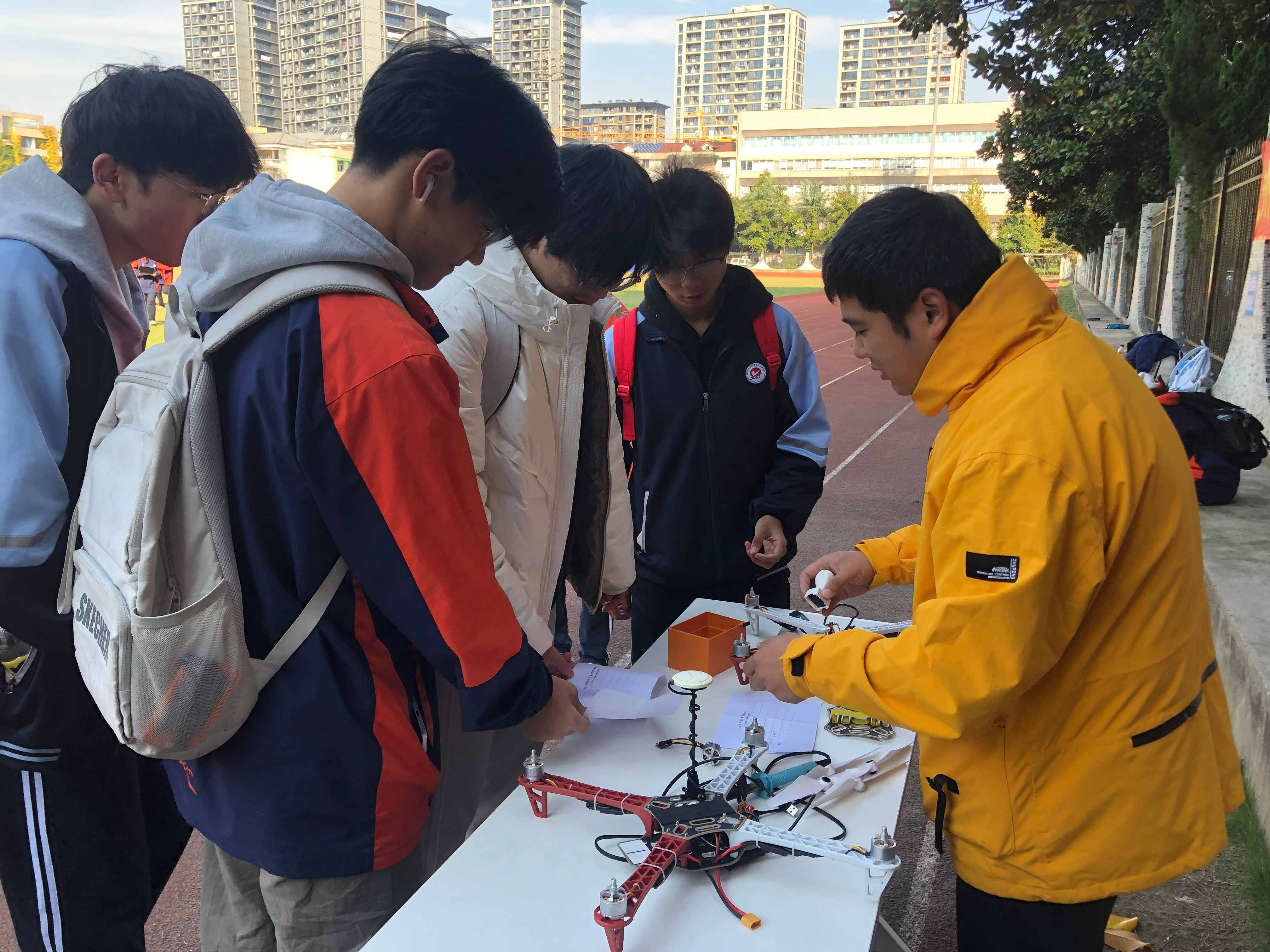 Instructor teaching students with a drone during practical training